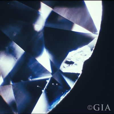 A photo of a chip. A type of diamond inclusion that looks like a chip.