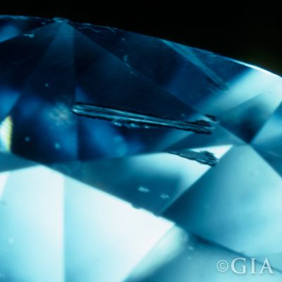 A photo of a needle. A type of diamond inclusion that looks like a straight line.