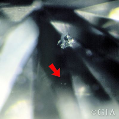 A photo of a pinpoint. A type of diamond inclusion that looks like a small dot.