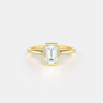 Parker No. 5 — a lab grown emerald set north-south in a yellow gold bezel setting.