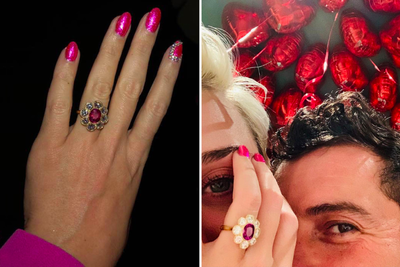 Katy Perry showing off her ruby engagement ring surrounded by prong set diamonds.
