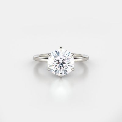 A white gold engagement ring featuring a round diamond shape