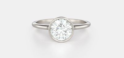 A round brilliant diamond set in a platinum bezel setting. The best diamond shape for sparkle.