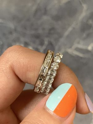 Two carat baguette channel band and emerald round eternity band in yellow gold