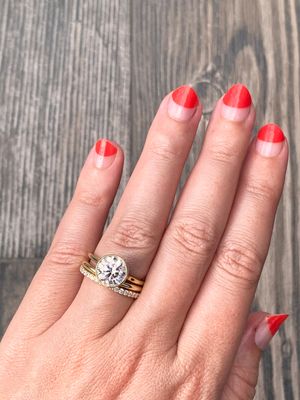 Round bezel solitaire engagement ring stacked with 1/2 carat diamond eternity band