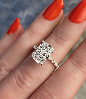 Frank Darling radiant solitaire diamond engagement ring with a marquise eternity band
