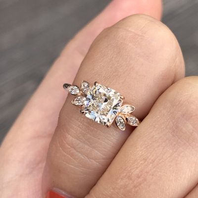 Unique Engagement Ring with prong set heirloom cushion center diamond and six marquise side set stones in rose gold with 1.5 carats of natural diamonds