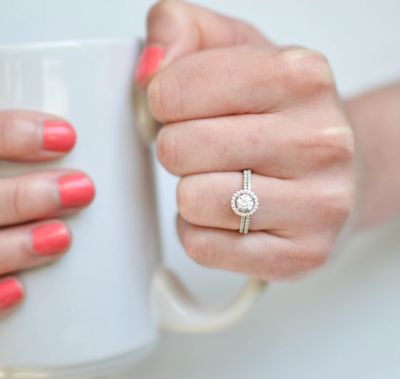 Halo engagement ring with gap between center stone and halo