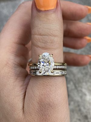 frank darling oval thin band engagement ring stacked with a baguette channel band and pave band