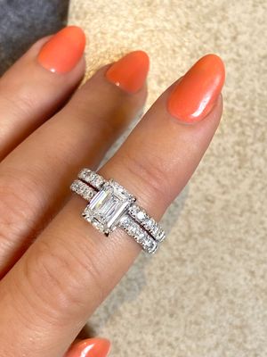 Frank Darling Sidney emerald engagement ring paired with a 2mm french pave eternity band