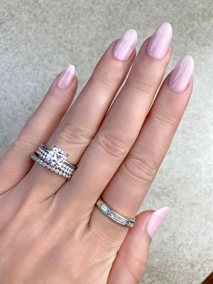 thin band cushion cut engagement ring stacked with diamond bands