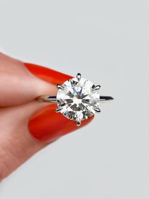 frank darling round solitaire engagement ring on a knife edge band set with a 3 carat diamond