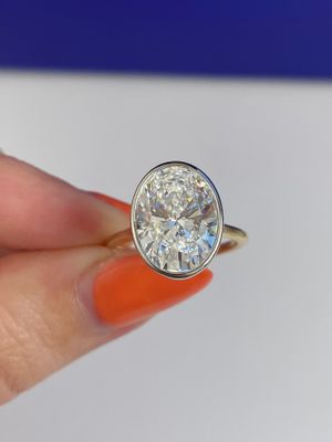 Frank Darling custom 7 carat oval diamond bezel two tone engagement ring.