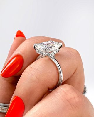 emerald plunge diamond engagement ring with diamond accents in platinum