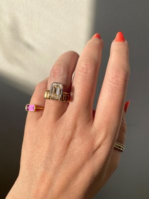 Frank Darling emerald cut diamond two-tone bezel ring.