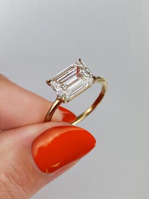 East west yellow gold emerald cut diamond engagement ring